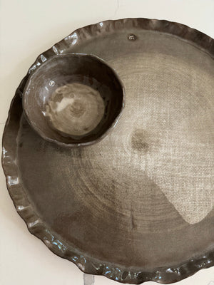 Decorative metal tray with a central bowl on a white background
