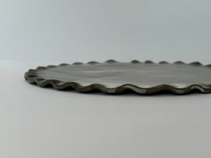 Black ceramic platter on a light gray background