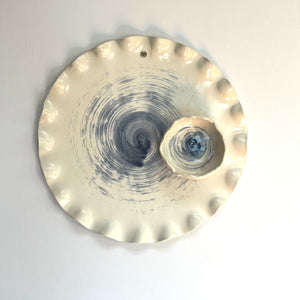 Round shaped ceramic platter and a bowl with blue circular pattern on white base and grey background